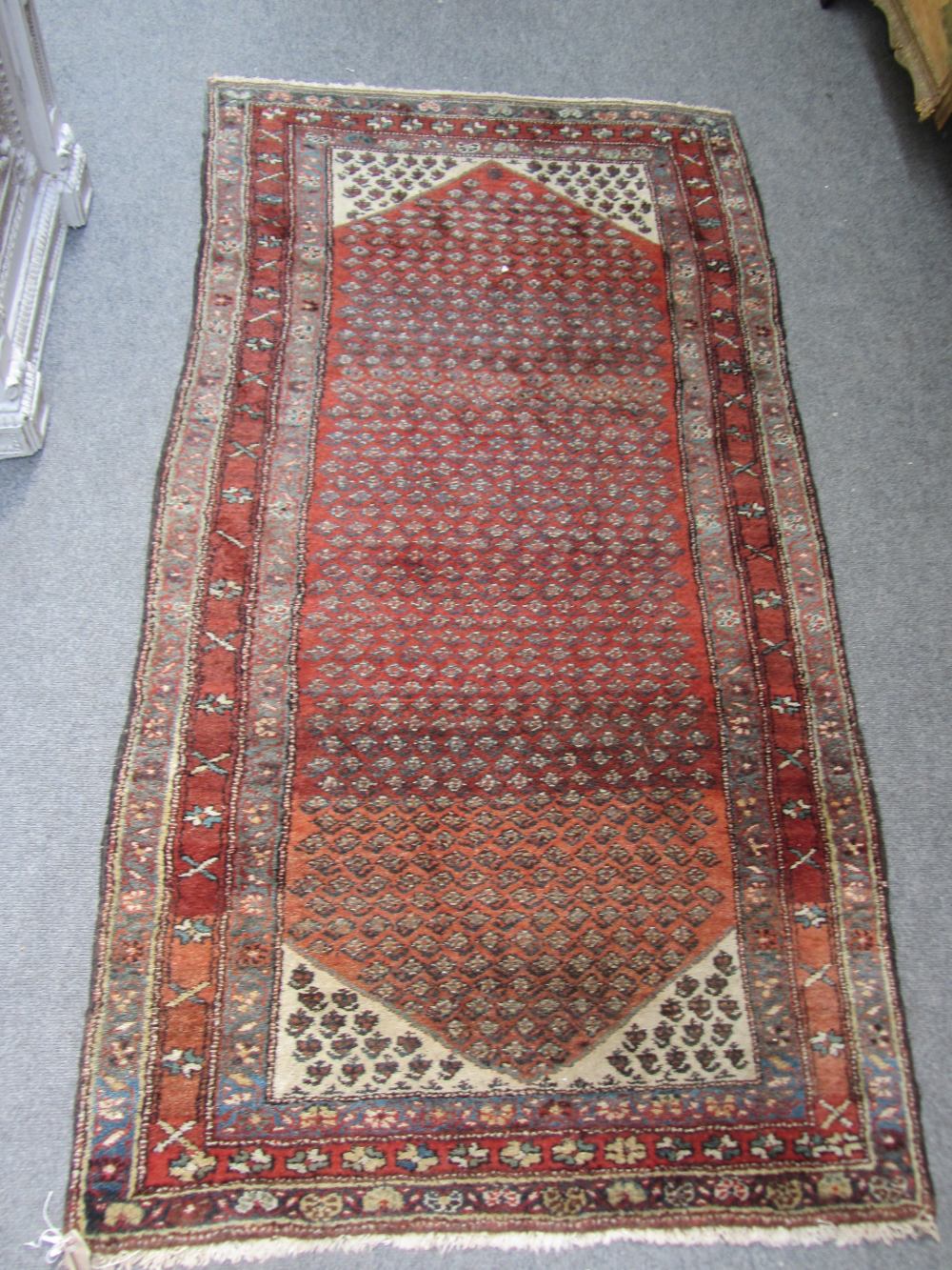 A Bidjar rug, Persian, the madder field with an allover herati design, ivory spandrels, three - Image 2 of 7