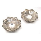 Two similar silver pedestal fruit tazzae, each of shaped octagonal form, embossed with floral,