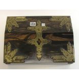 A 19th century Gothic Revival gilt metal mounted coromandel slope front writing box with fitted