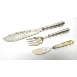 A pair of Victorian silver fish servers, with pierced and engraved decoration and with loaded