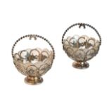 A pair of Victorian silver bonbon baskets, each of lobed circular openwork form, decorated with