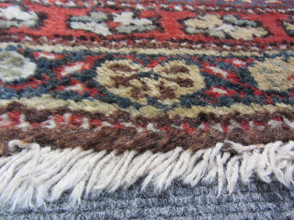 A Bidjar rug, Persian, the madder field with an allover herati design, ivory spandrels, three - Image 6 of 7