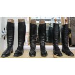 Three pairs of leather riding boots with wooden trees.