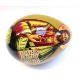 A Russian lacquered papier mache egg, decorated with 'The Holy Father' (11.5 cm) and three other