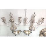 A pair of plated adjustable three light table candelabra, each with fluted scrolling arms and on