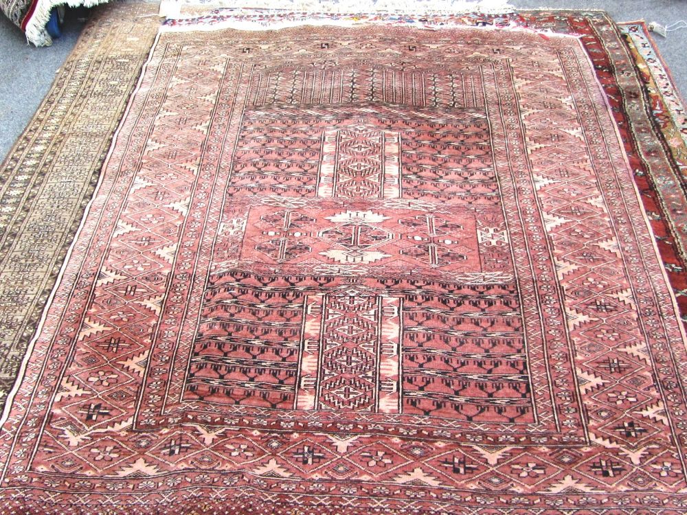 A Turkeman Ensi rug, the madder field with candelabra quarters, arches above, a diamond border,