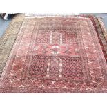 A Turkeman Ensi rug, the madder field with candelabra quarters, arches above, a diamond border,