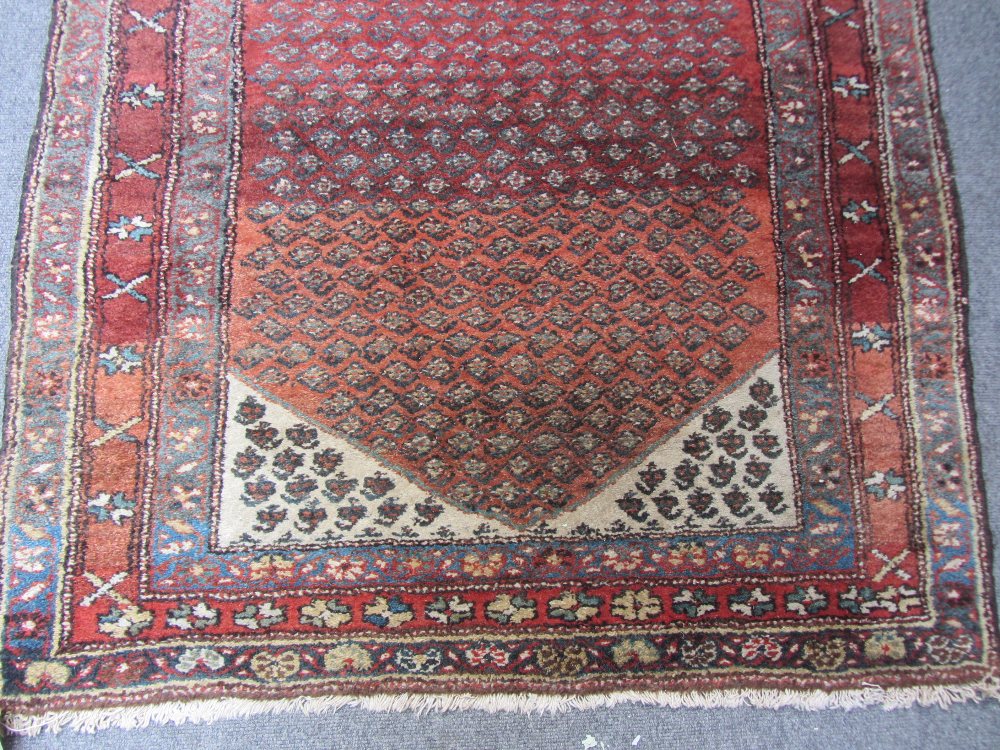 A Bidjar rug, Persian, the madder field with an allover herati design, ivory spandrels, three - Image 4 of 7