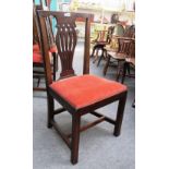 A set of six late George III mahogany dining chairs with pierced vase back and block supports.