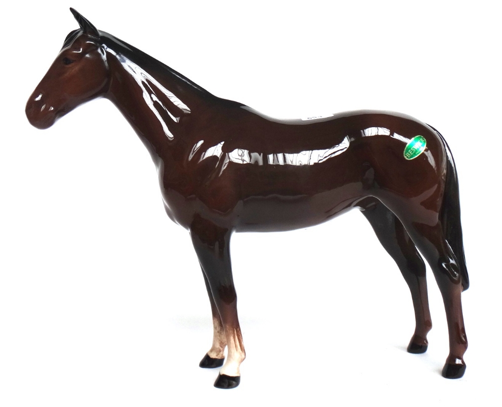 A Beswick shire horse (matt finish), two Beswick brown gloss horses and a Beswick brown gloss foal