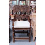 A 17th century style Continental walnut open armchair with carved back on square baluster supports.