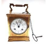 A French gilt brass cased carriage clock with foliate painted enamel dial and plinth base and a two