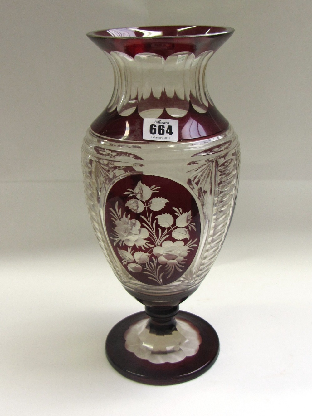 A clear and ruby cut flashed glass vase, late 20th century, with outurned rim and a body decorated