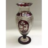 A clear and ruby cut flashed glass vase, late 20th century, with outurned rim and a body decorated
