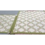 Two Portuguese needlework carpets, the ivory field with a leaf spray and flower trellis design, a