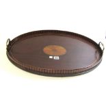 An Edwardian inlaid oval galleried serving tray with brass loop handles, 58cm wide.