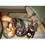 A Royal Doulton figure of a lady, another of a man and a table lamp mounted with a glass swan.