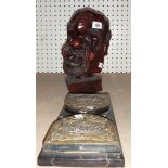 A tribal hardwood carved head of a man, together with an ebonised brass mounted book slide.