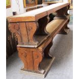 A pair of Victorian oak rectangular benches, each on double shaped slab end supports, 268cm wide.