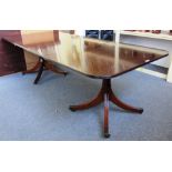 A William Tillman twin pedestal mahogany extending dining table on eight downswept supports,