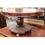A William IV rosewood loo table with oval snap top and flared circular base, 135cm x 120cm.