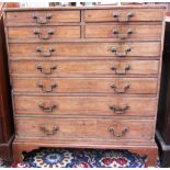 An early 19th century pine chest of four short and five long graduated drawers, on bracket feet,