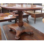 A William IV mahogany oval pedestal table on an octagonal baluster pillar with lotus carving to the