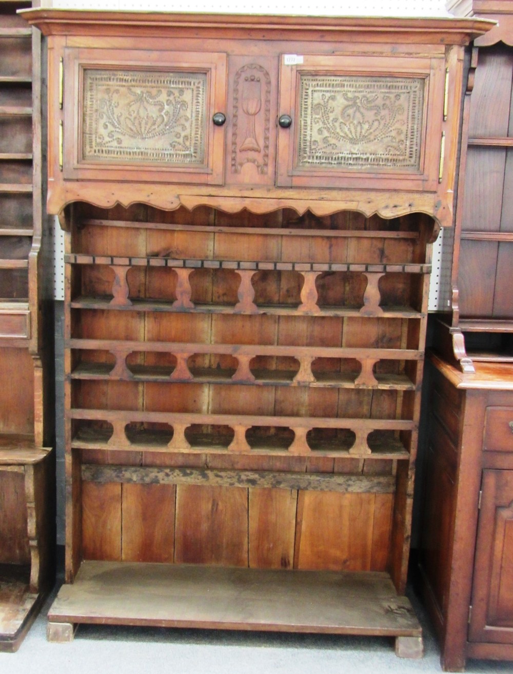 A 19th century French walnut floor standing three tier plate rack with pair of upper cupboards,