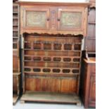 A 19th century French walnut floor standing three tier plate rack with pair of upper cupboards,