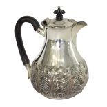 A late Victorian silver hot water jug, of baluster form, decorated with bold acanthus leaves,