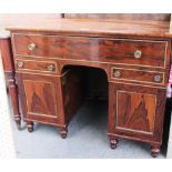 An early 19th century gilt metal mounted rosewood knee hole writing desk on turned feet, 107cm wide.