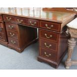 A late 19th century crossbanded mahogany pedestal desk with nine drawers about the knee, 122cm wide.