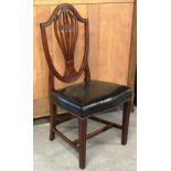 A set of six George III mahogany shield back dining chairs on square supports.