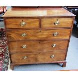 A George III mahogany chest of two short and three long graduated drawers, on bracket feet,