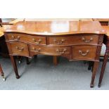 A late 19th century mahogany serpentine dressing table with five frieze drawers on tapering square