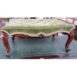 An early Victorian rosewood framed footstool of serpentine outline on cabriole supports,