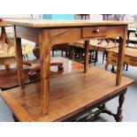 An 18th century French cherry wood plank top table with single frieze drawer,