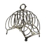 A silver George IV seven bar toastrack, of curved form, raised on a rectangular arched base,