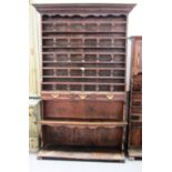 A 19th century French pine and chestnut floor standing seven tier plate rack with a trio of drawers,