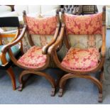 A pair of late 19th century Spanish walnut Savonarola chairs with lions mask finials.