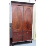A George III mahogany hall cupboard, the pair of doors designed as a faux linen press,