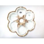 A set of eleven Limoges porcelain oyster dishes, each moulded with six compartments,