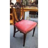 A set of six 19th century mahogany shield back dining chairs on tapering square supports.