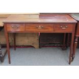 A George III mahogany rectangular three drawer writing table on tapering square supports,