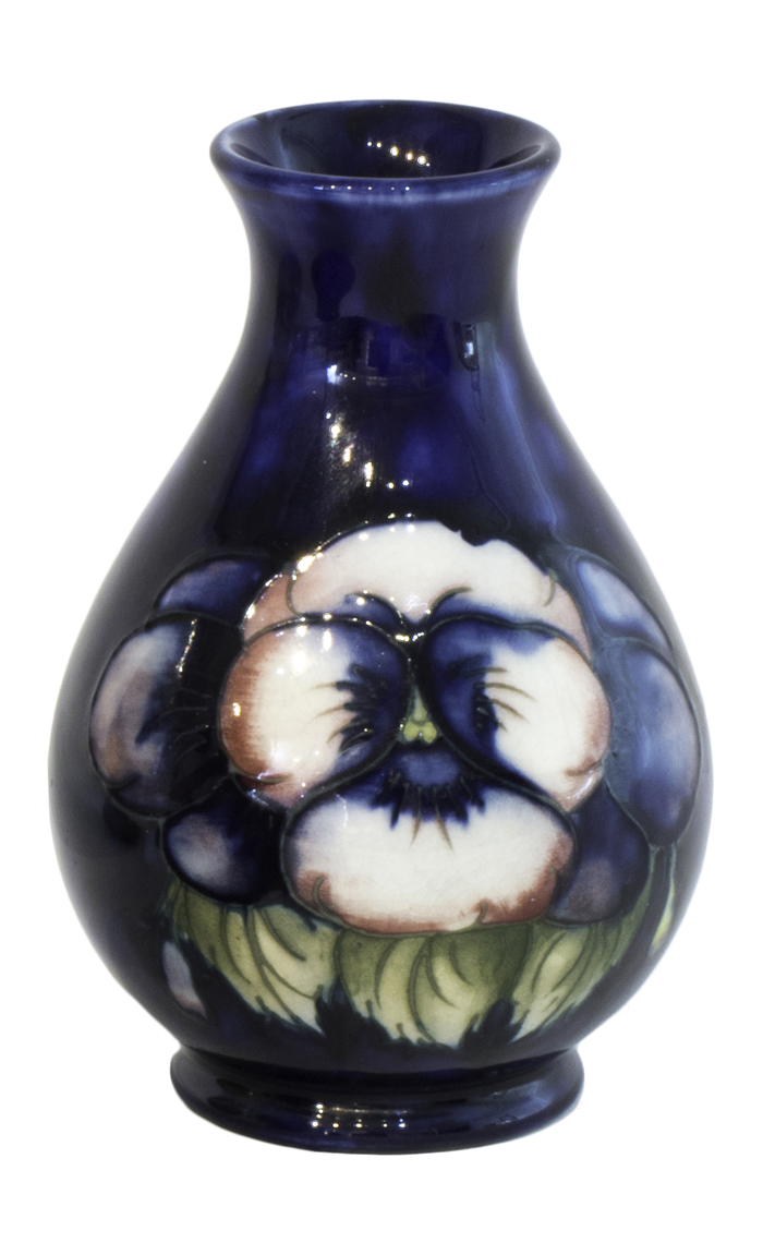 A Moorcroft pottery vase, early 20th century, decorated with pansies against a cobalt blue ground,