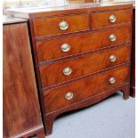 A George III mahogany chest of two short and three long graduated drawers on bracket feet,