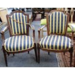 A pair of 18th century walnut framed fauteuils on tapering fluted supports.