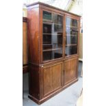 A Regency mahogany display cabinet, the pair of glazed doors over panel doors on a plinth base,