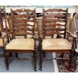 A set of six oak and ash 18th century style wavy ladder back chairs, to include a pair of carvers.