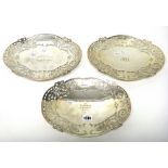 A group of three silver dishes, of shaped oval form, with pierced decoration,